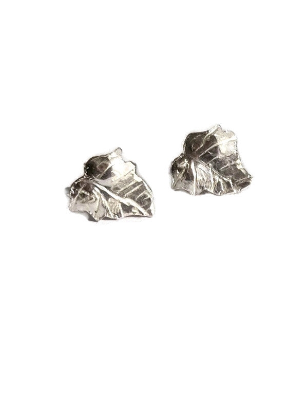 A pair of textured silver ivy leaf stud earrings on a plain white background.
