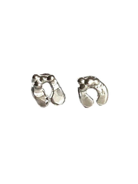 Very small sterling silver mistletoe leaf stud earrings on white background