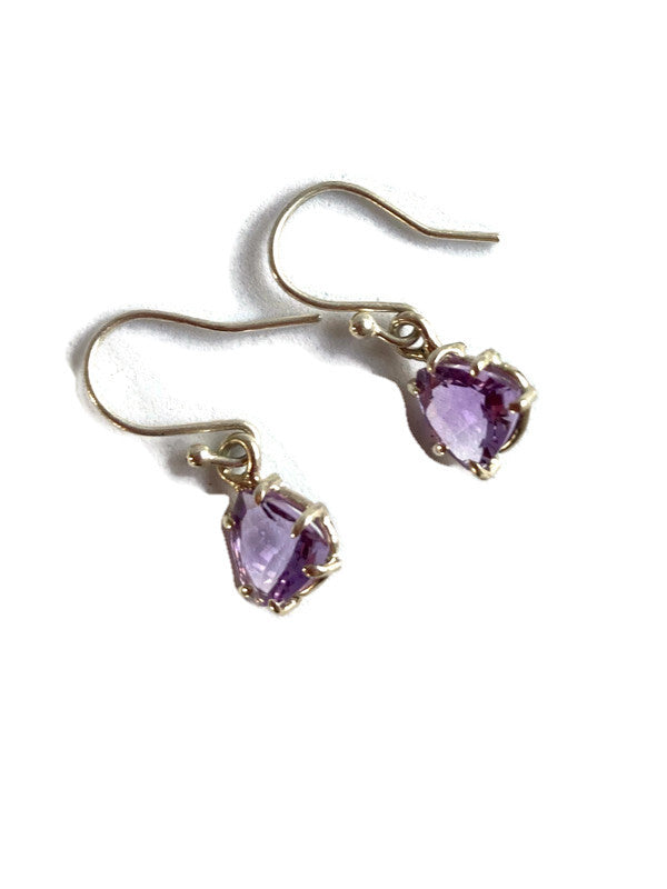 silver earrings with purple amethyst trillion gemstones on a white background