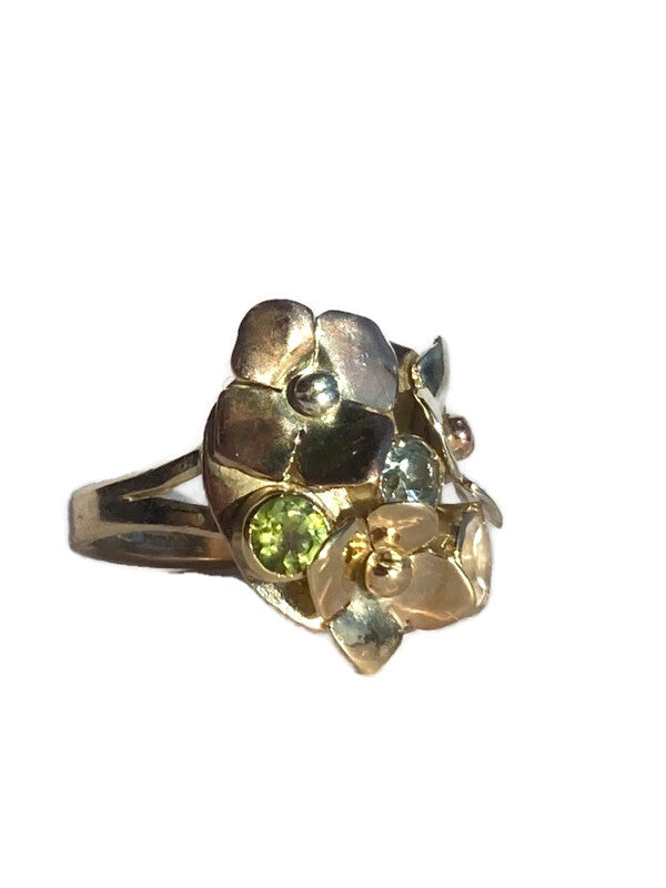 Gold flower cluster ring with green  and blue gemstones on a white background by Kim Styles Jewellery