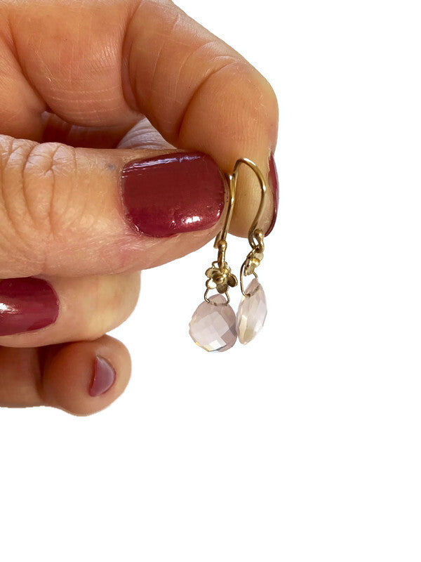 Kim Styles gold floral rose quartz briolette drop earrings held in fingers, against white background