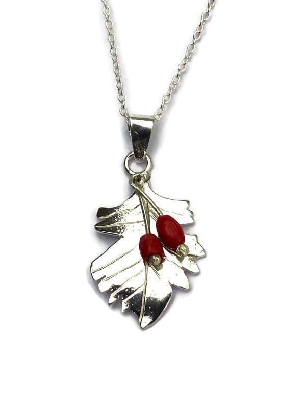 A silver Hawthorne leaf pendant necklace featuring two small red berry accents, shown on a clean white background.