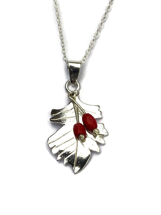A silver Hawthorne leaf pendant necklace featuring two small red berry accents, shown on a clean white background.