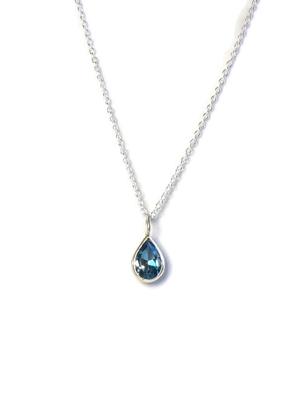 Kim Styles handmade London blue topaz teardrop-shaped pendant necklace on a white background