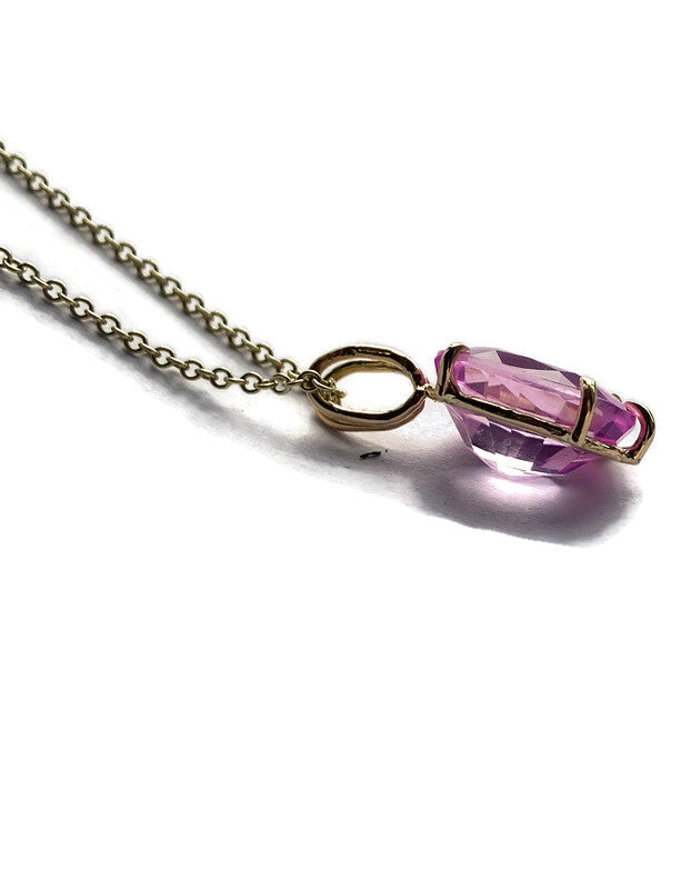 luxury 11ct pink spinel large oval pendant set in gold prong setting on gold chain,  hand made by Kim Styles, side view on white background
