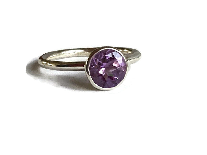Kim Styles halo silver ring set with a large round amethyst gemstone on a white background