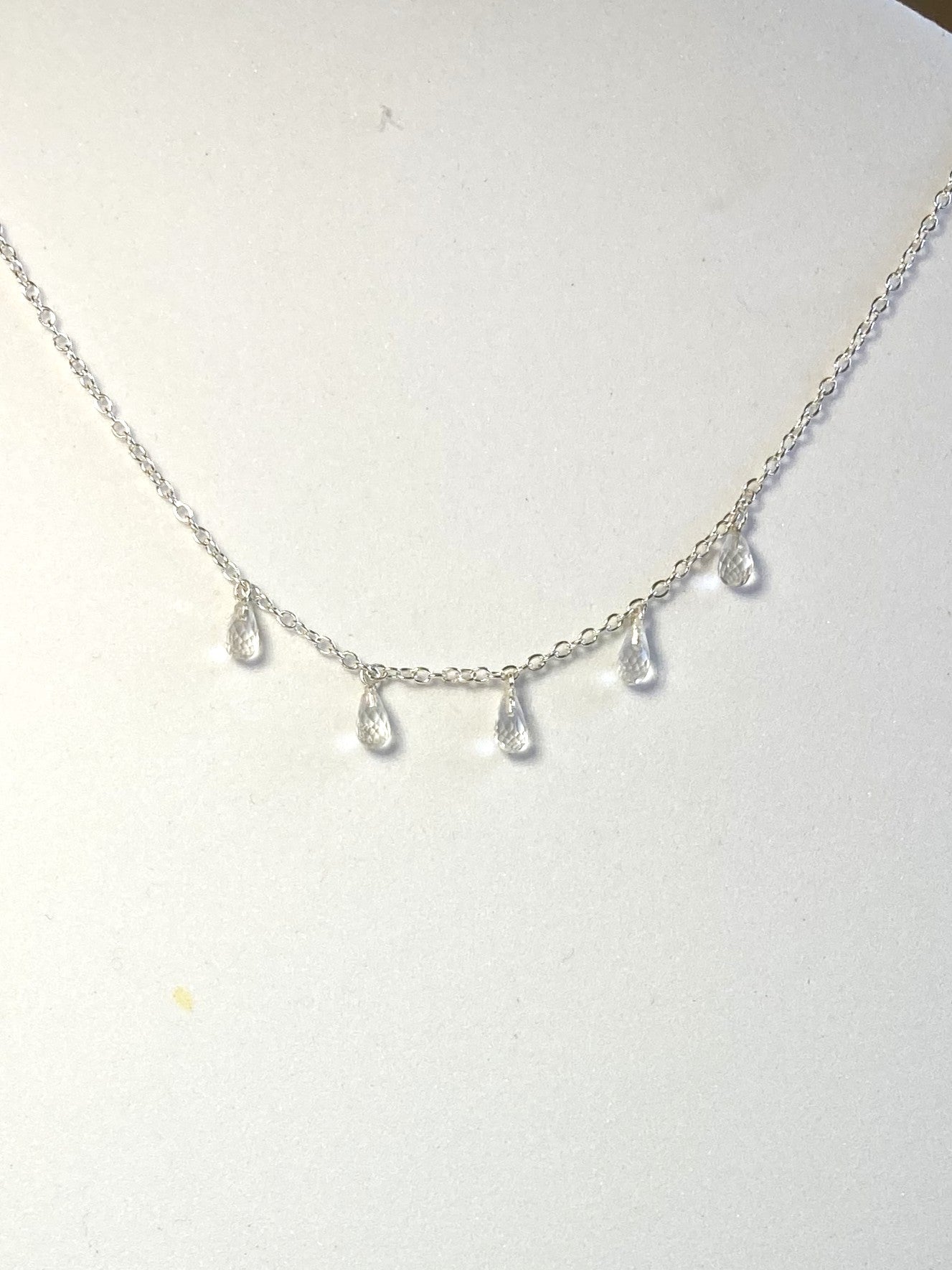 Kim Styles silver necklace with white topaz teardrop-shaped pendants on a white background