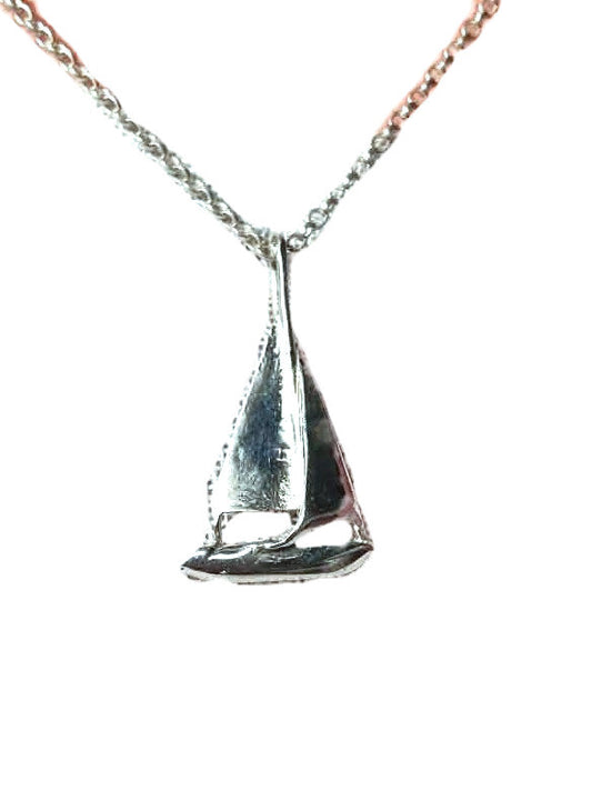 A silver pendant necklace featuring a  sailboat design hanging from a delicate chain, isolated on a white background.