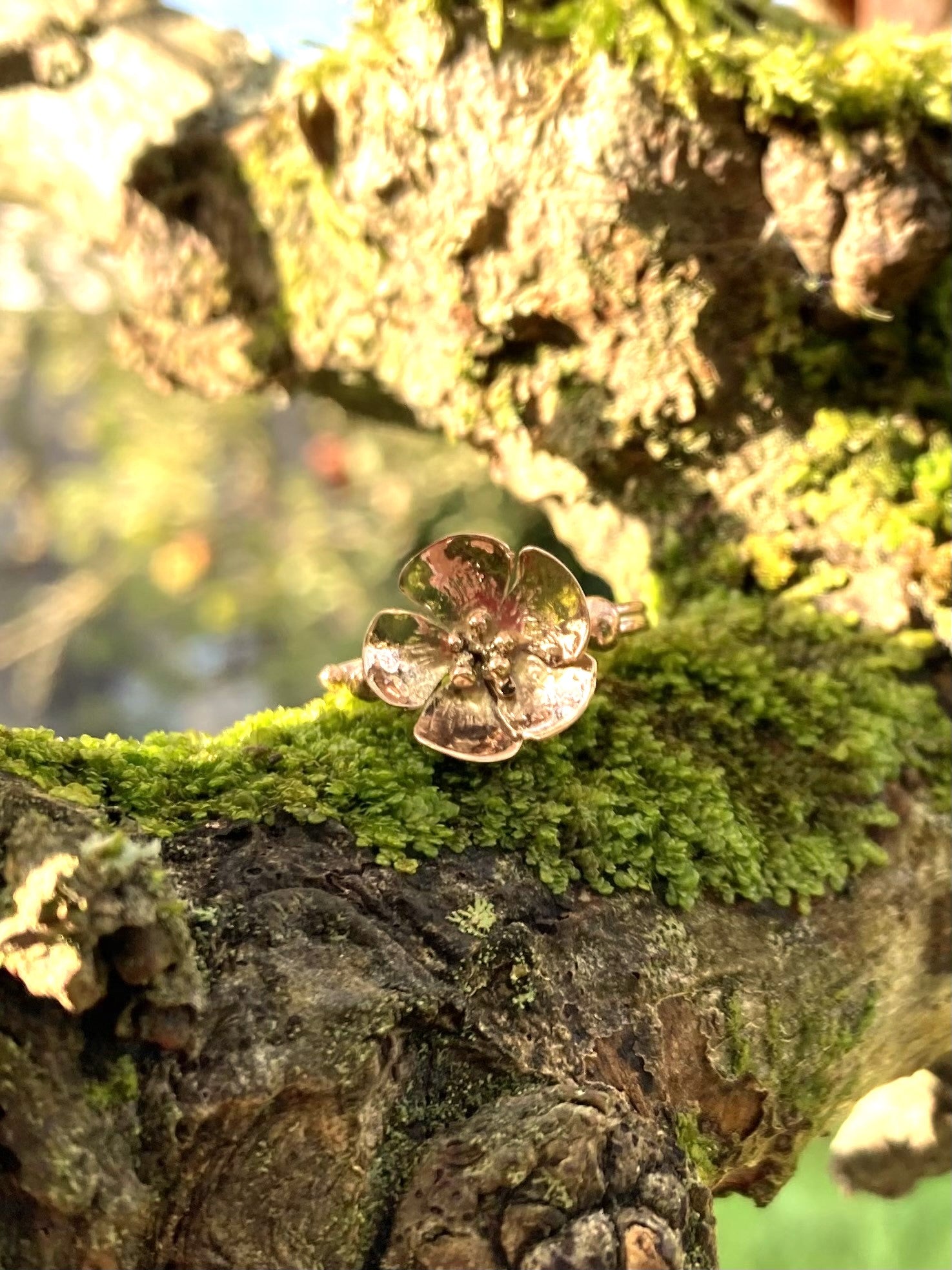 rose gold large flower ring on mossy branch