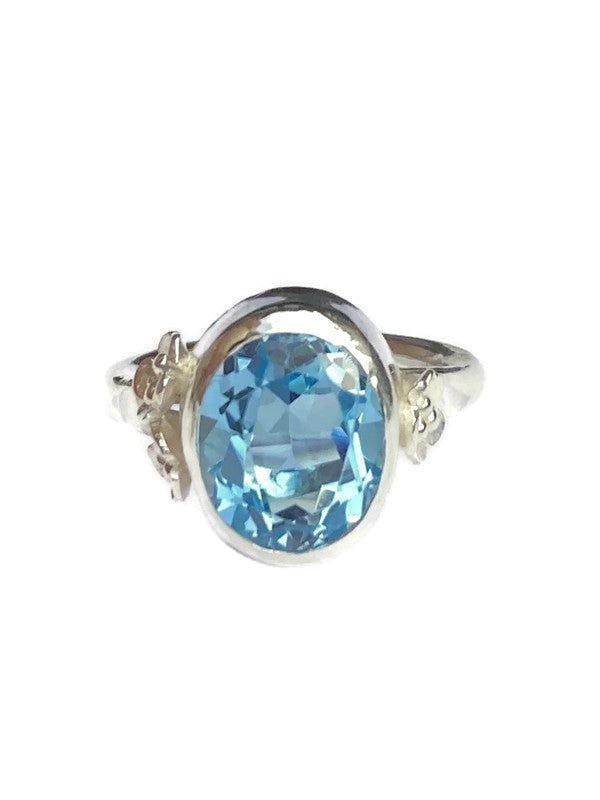 Kim Styles silver cocktail ring with a blue topaz gemstone on a white background