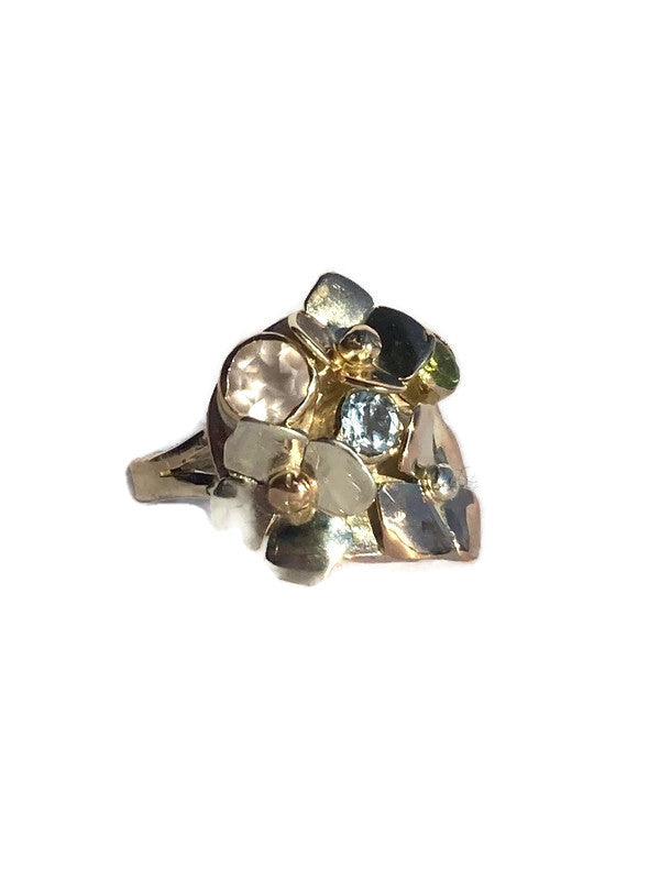 Gold cluster ring with multi coloured gemstones on a white background by Kim Styles Jewellery