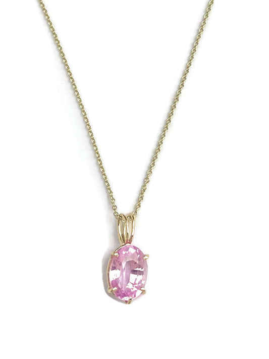 luxury 11ct pink spinel large oval pendant set in gold prong setting on gold chain, by Kim Styles, on white background
