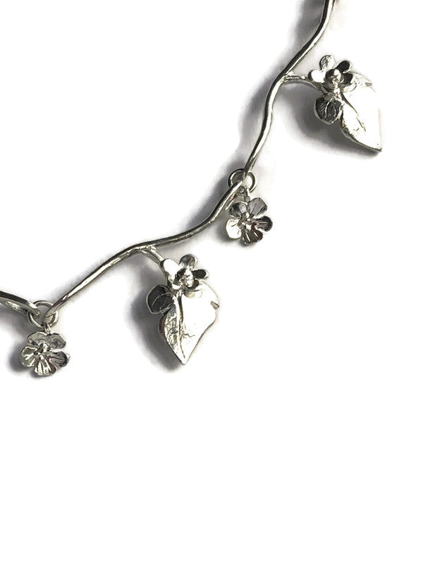 close up detail of floral and leaf necklace by Kim Styles Jewellery, on a white background