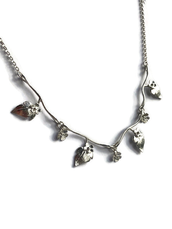 silver floral and leaf necklace by Kim Styles Jewellery, on a white background
