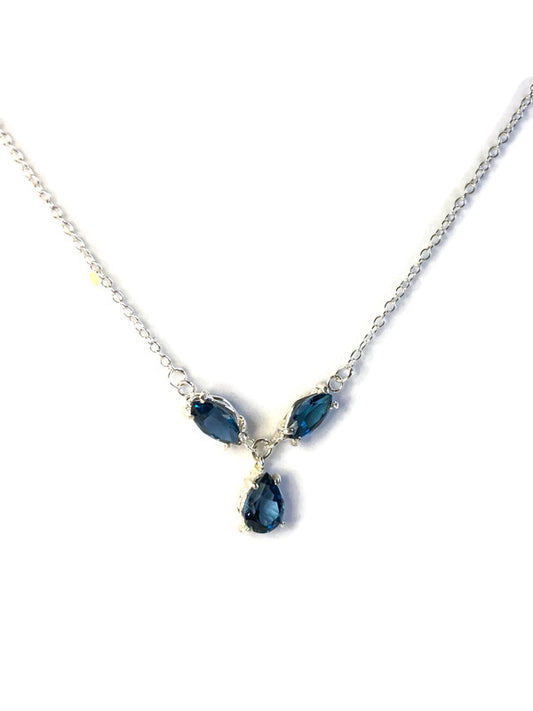 Kim Styles necklace with London  blue topaz marquise and teardrop-shaped gemstones on a white background