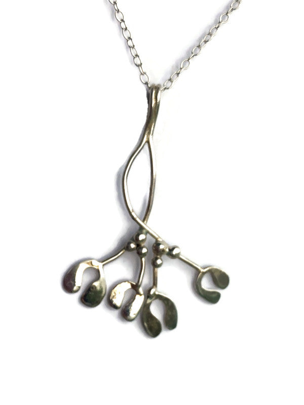 A sterling silver mistletoe pendant necklace by Kim Styles Jewellery,  on a delicate chain, set against a plain white background.