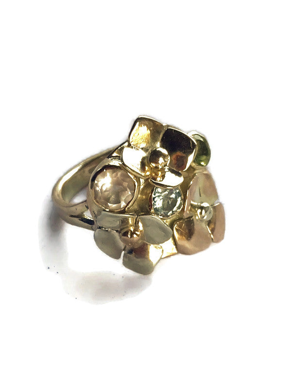 Gold cocktail ring with floral design and embedded stones on a white background by Kim Styles Jewellery