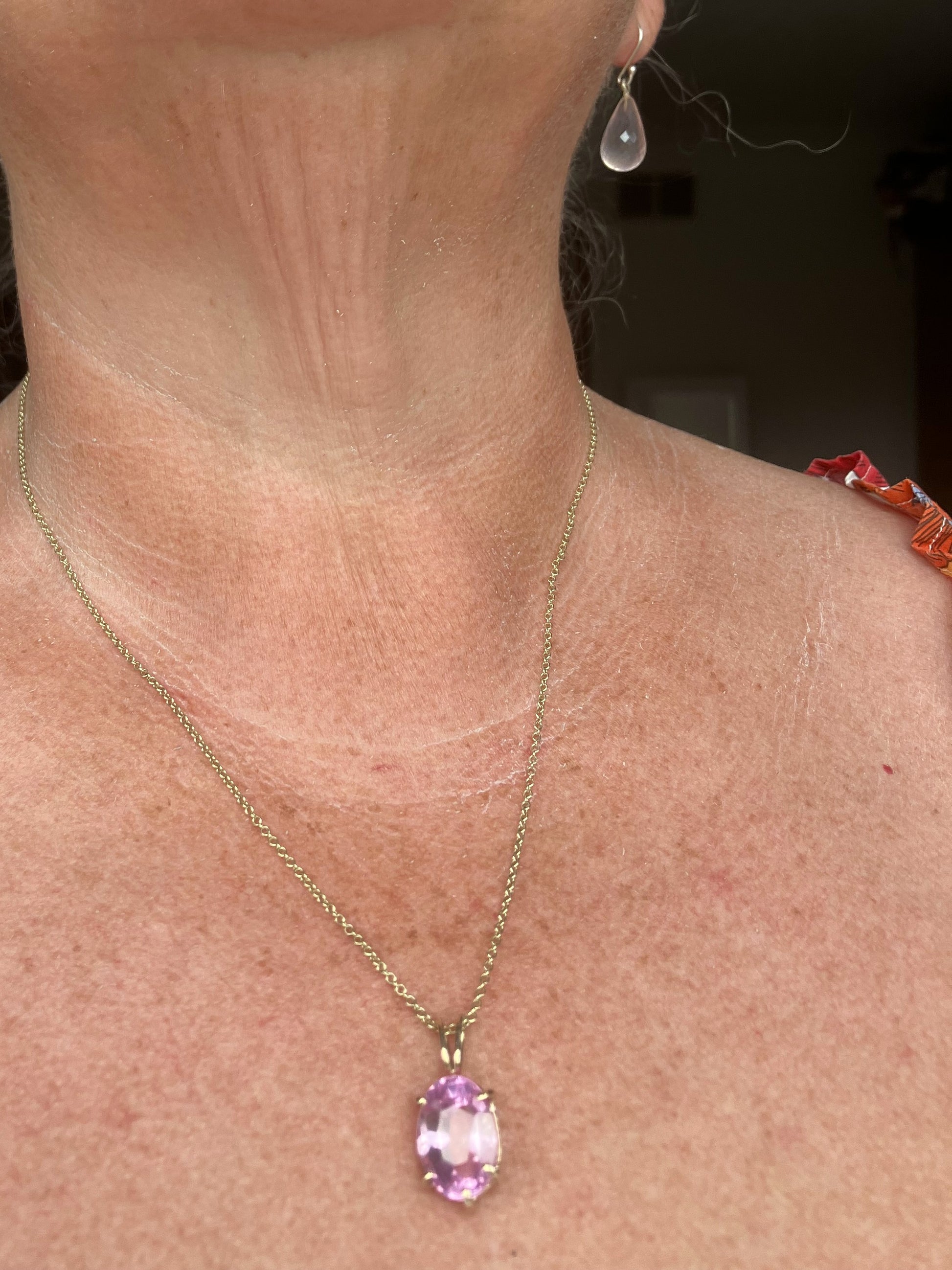 large luxury 11ct  deep pink spinel oval pendant set in gold prong setting on gold chain,  hand made by Kim Styles, on ladies neck