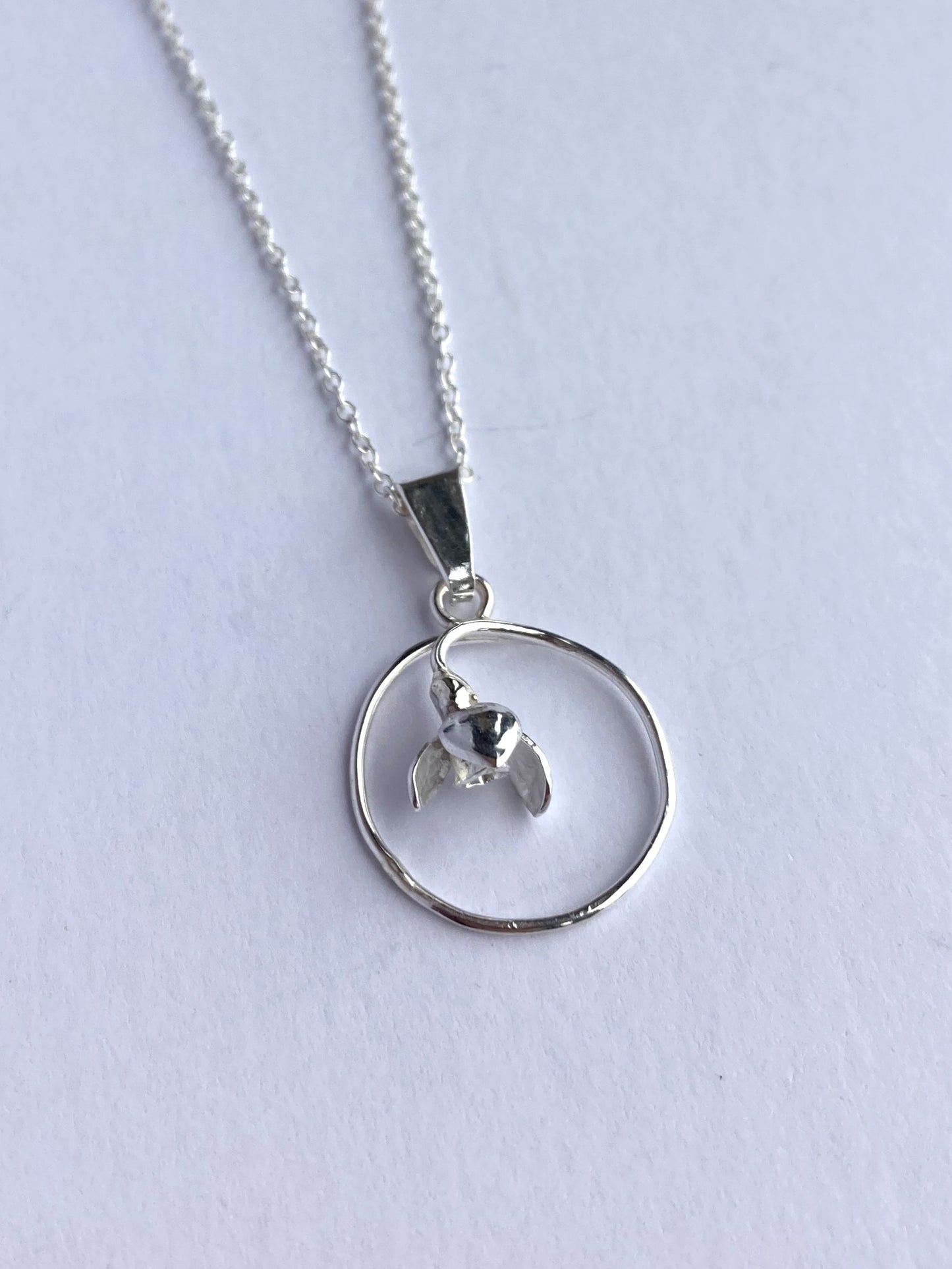 Floral snowdrop pendant on grey background