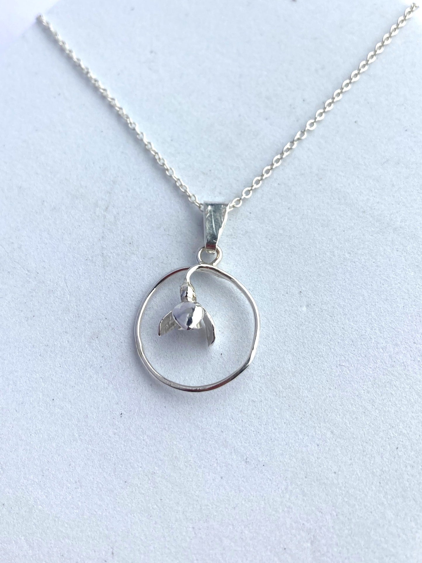 Simple snowdrop flower pendant by Kim Styles Jewellery  on grey background