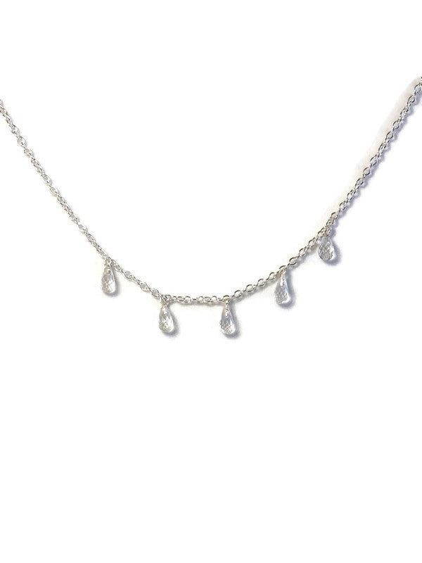 Kim Styles silver necklace with teardrop-shaped white topaz pendants on a white background