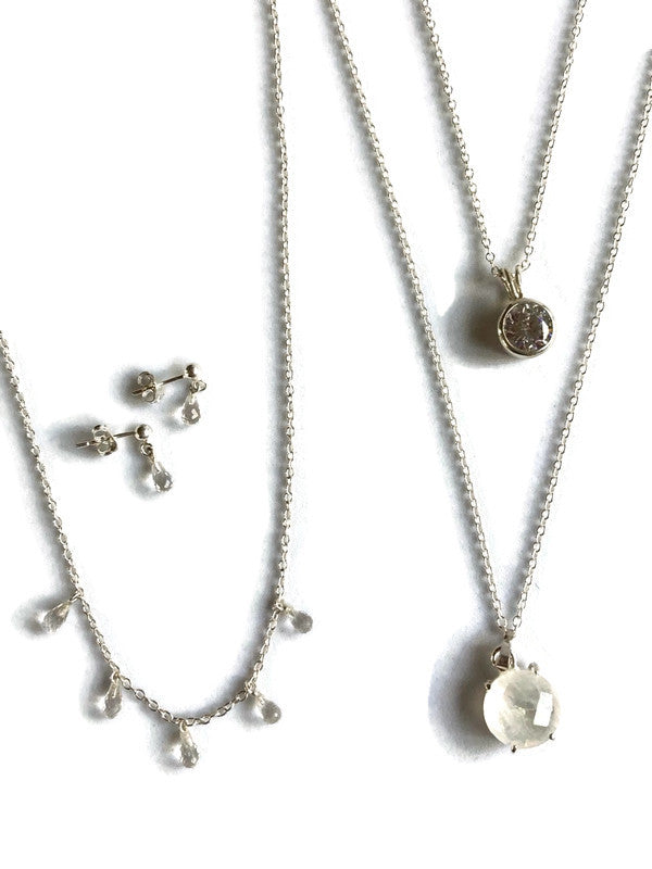 Kim Styles white gemstone silver jewellery set with necklaces and earrings on a white background