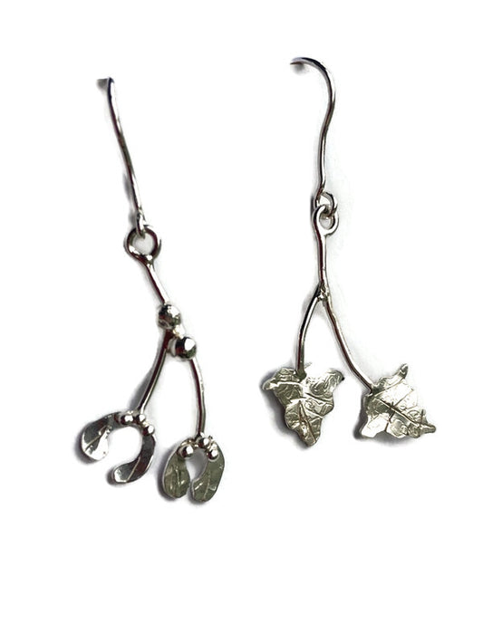 Mismatched dangle drop earrings in sterling silver with a mistletoe and ivy theme, on a white background