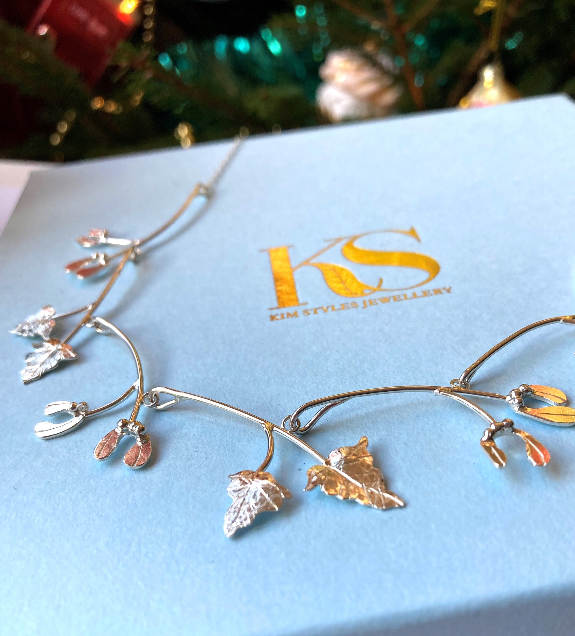 silver mistletoe and vine handmade necklace on Kim Styles Jewellery logo blue box
