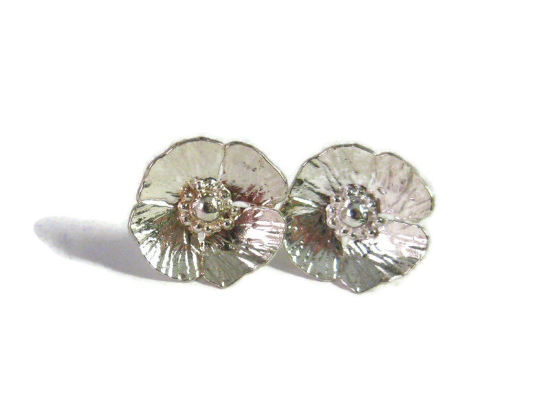 textured poppy stud earrings in silver, on white background
