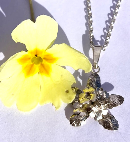 Yellow primrose flower with silver hand made primrose and leaves pendant