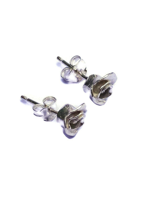 side view of silver rosebud earrings with pins and scrolls, on white background
