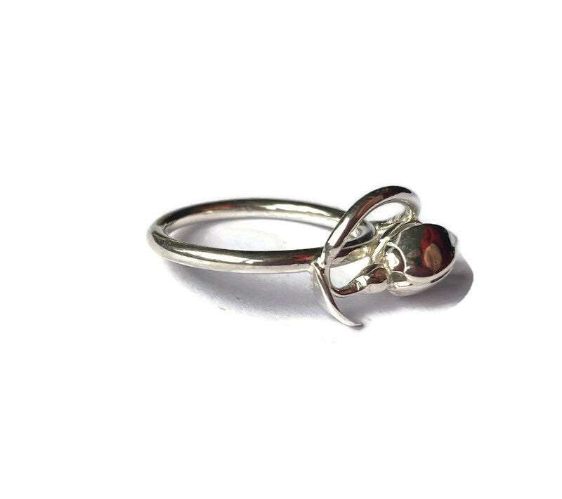 side view art nouveau style silver snowdrop ring on white background