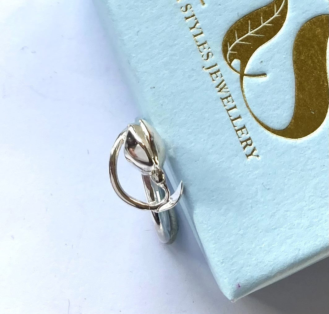 curving silver snowdrop flower ring, leaning on pale blue ox with Kim Styles Jewellery logo