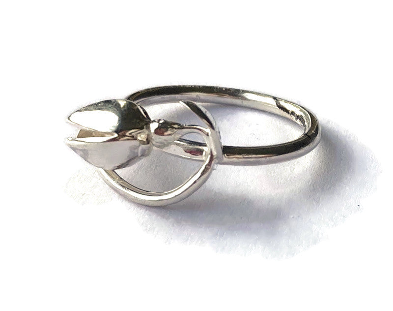 art nouveau style curving silver snowdrop ring, on white background