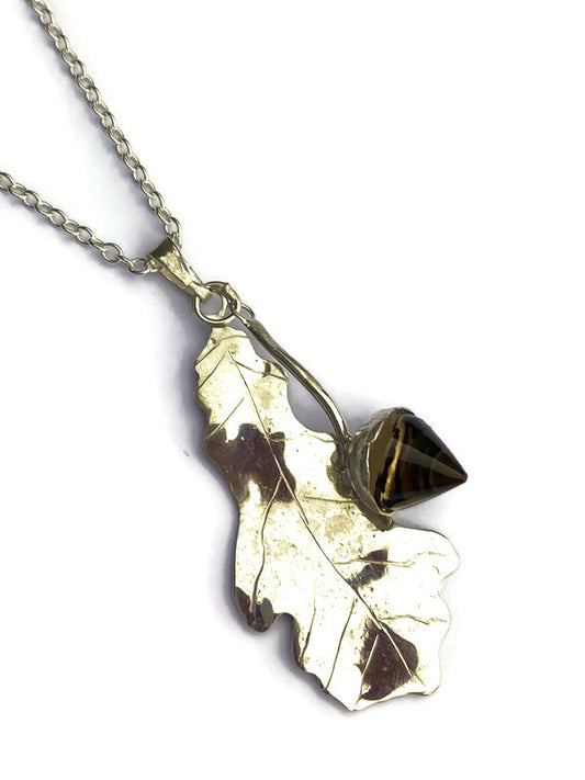 silver oak leaf pendant with Smokey quartz acorn on white background 