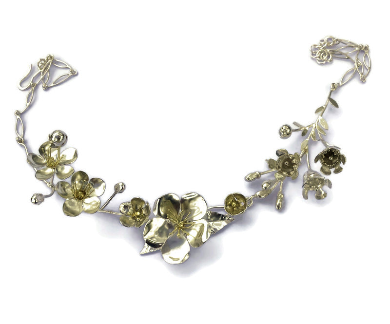 Statement floral necklace with lifelike handmade silver flowers, bridal necklace on white background