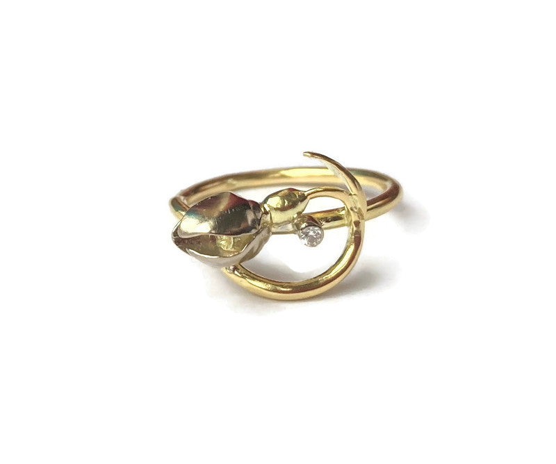 white and yellow gold ring in shape of  curved snowdrop flower