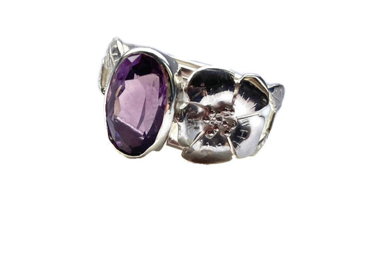 oval purple gemstone ring with large silver flower