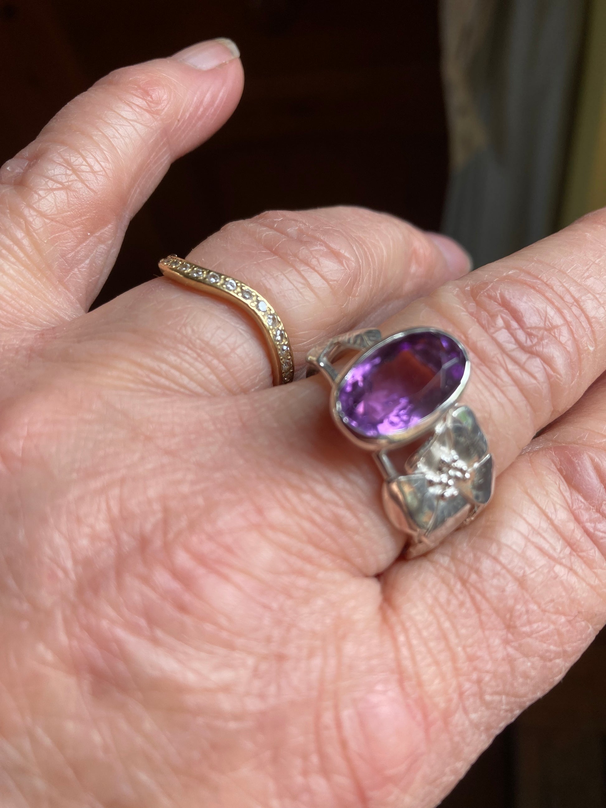 floral silver ring set with large amethyst on hand
