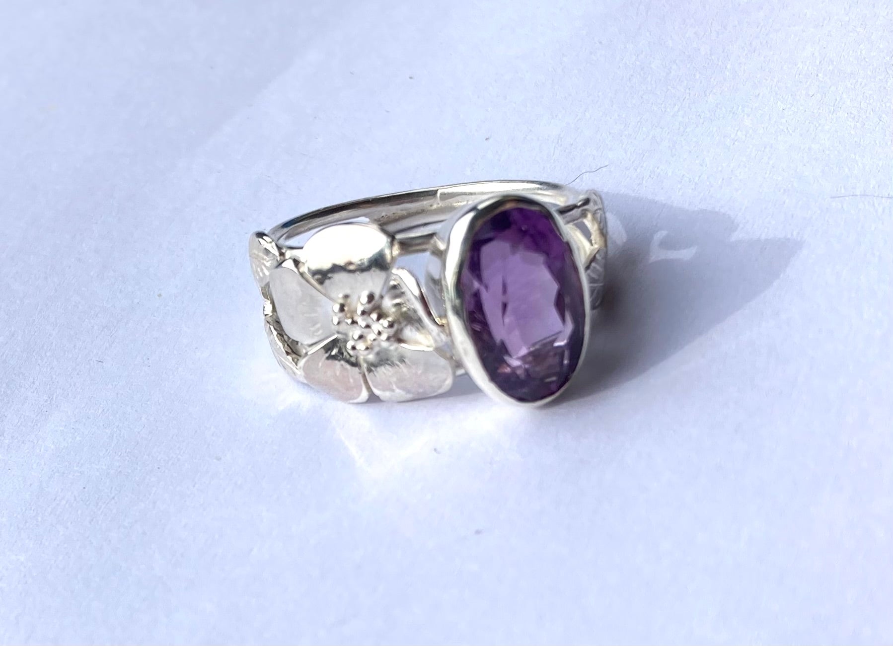floral rose ring with big amethyst on white background