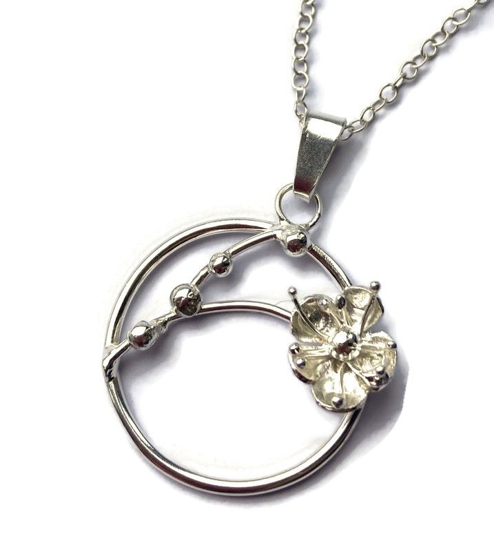 sakura cherry blossom circle pendant with single flower, on white background