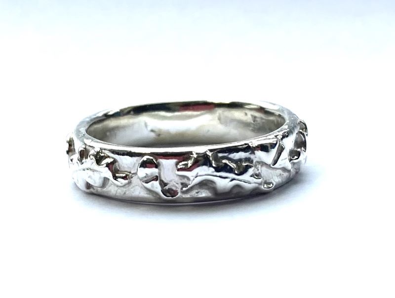 white gold wedding band with oak leaves and acorns pattern, on white background 
