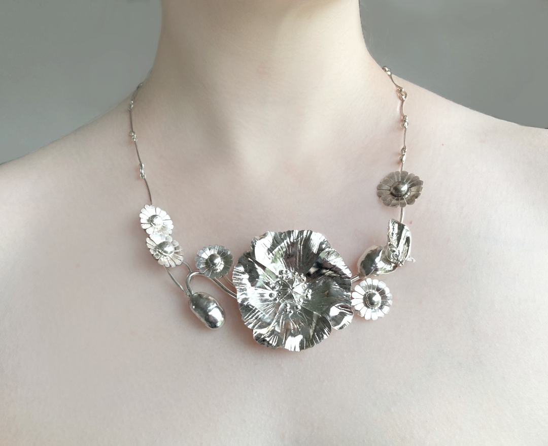 botanical floral statement silver necklace, on woman's neck