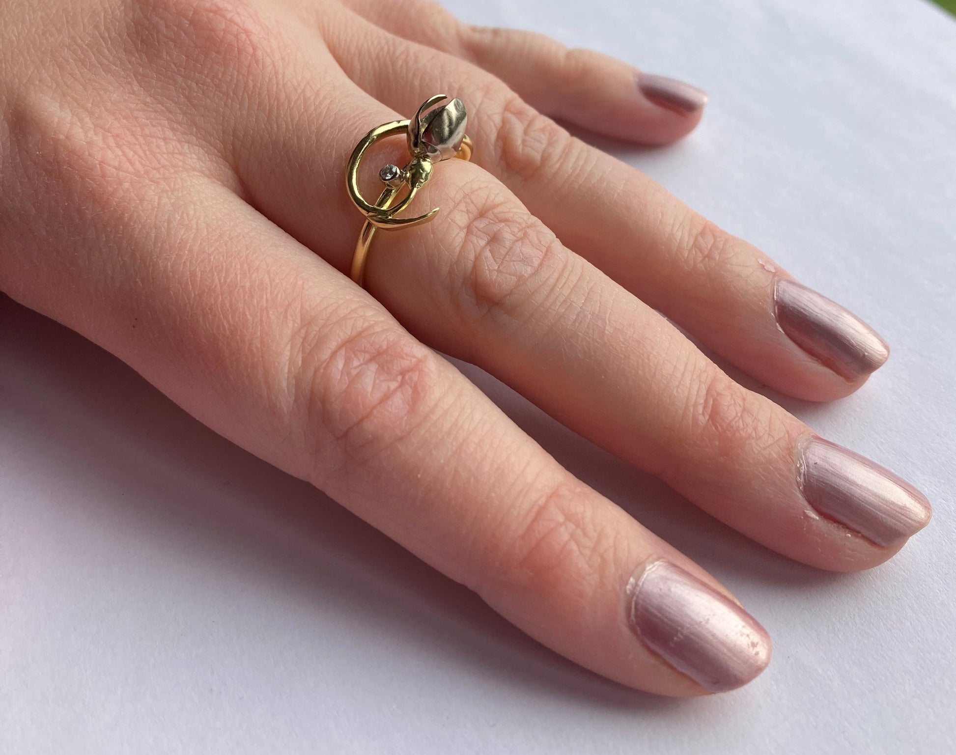 art nouveau style gold ring in shape of a snowdrop flower, on hand